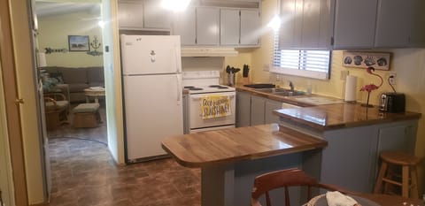 Kitchen furnished with dishes, pots and pans.
Crockpot, toaster, microwave etc 