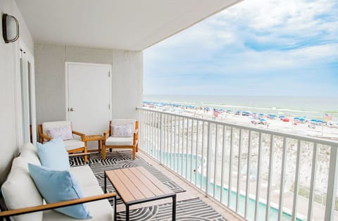 Private beachfront balcony with comfy seating and sweeping ocean views