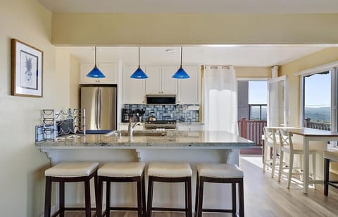 Generous, open concept kitchen with bar stools to also eat at the countertop