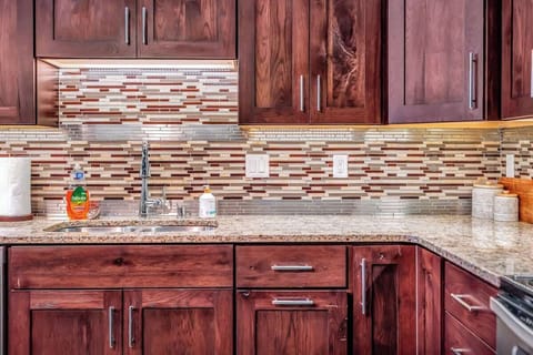 Fully equipped kitchen with granite countertops, stove, microwave, dishwasher, refrigerator, and ice maker. Includes all essential cookware, dinnerware, and barware.