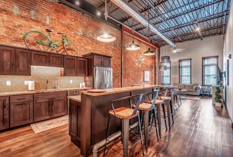 Large Kitchen Island with open concept living room and kitchen. Granite countertops, stainless steal appliances, tons of amenities!