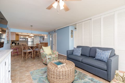 Unwind in your bright, coastal living room where soft blues and natural textures create the perfect beach retreat atmosphere.