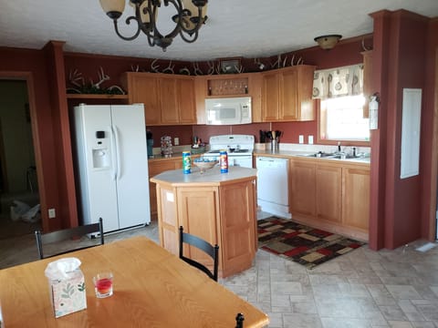 Beautiful open kitchen with a few snacks to enjoy. Deck and Grill access.