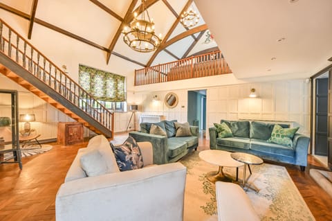Overview of sitting room with mezzanine above.