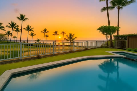 Relax poolside as the sky transforms with sunset hues.