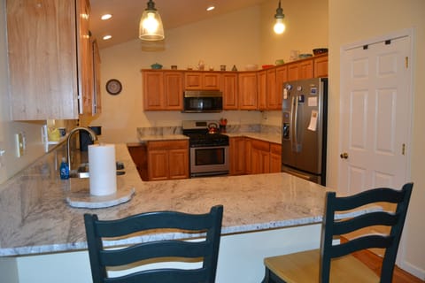 Kitchen view from dining area. Granite countertops.