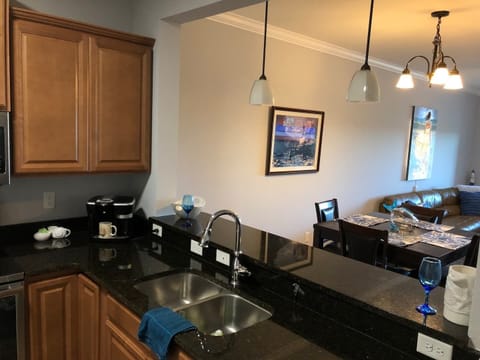 Looking out from kitchen. The counter has barstools