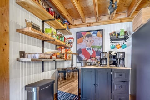 Fully stocked coffee/tea bar, wine/bev fridge/ lots of open shelving for snacks