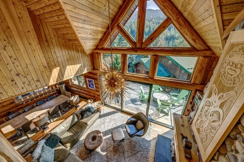 Huge ceiling living area with wood fireplace, custom chandelier and huge patio