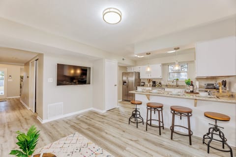 55 inch flat screen Roku TV. Additional seating at the kitchen counter.