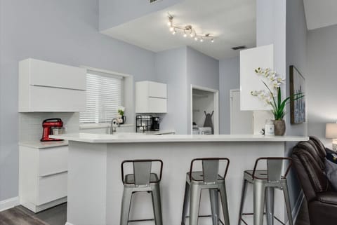 Gather around the spacious kitchen island, perfect for enjoying meals or sharing stories over coffee.