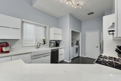 Bright white kitchen with ample space and all essentials—perfect for long stays and family gatherings.