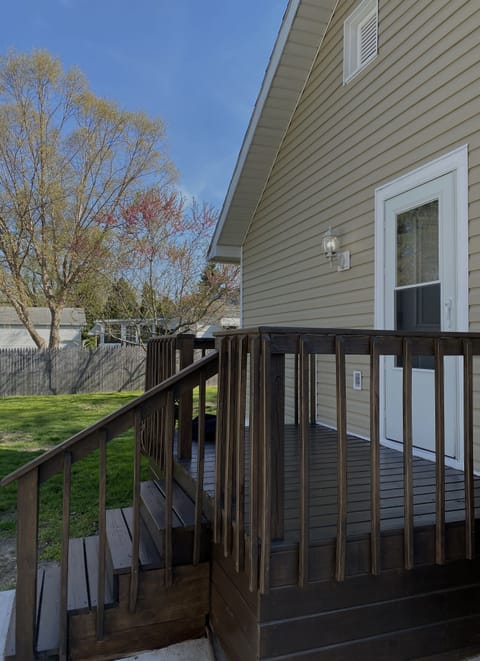 Deck overlooking spacious backyard w/seasonal flower, vegetable & herb gardens.