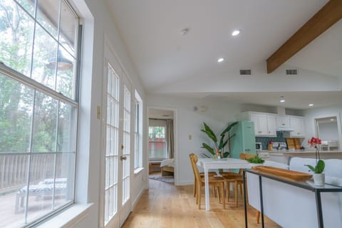 Living room, kitchen, and French doors leading to back deck
