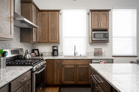 Kitchen island offers additional cooking space and bar seats for dining.