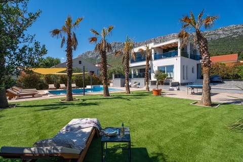 Outdoor offers  covered dining area (in front of the kitchen and living room) and, a barbecue