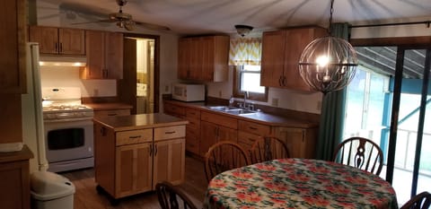 Kitchen and dining area with sliding glass door to screen-enclosed back patio