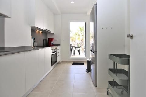 Modern kitchen is equipped with all appliances and has access to balcony