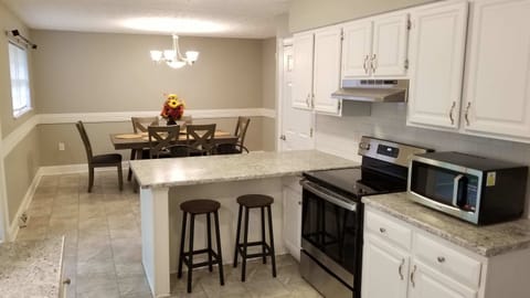 Large kitchen with coffee maker, crockpot, and Brita filtered water.