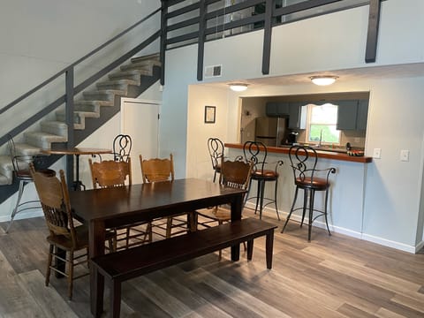 Dining area seating includes 6 at the table, 3 at the bar and 2 at the high top