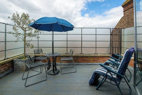 Rooftop Retreat: Enjoy stunning views while lounging under the sun with a refreshing drink!
