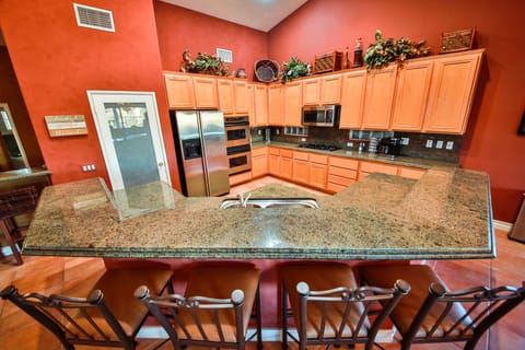 Fully stocked kitchen with bar seating and open to living room