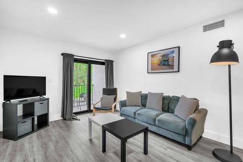 Serene and inviting living area with cushy seats, a coffee table, and seamless access to your own balcony