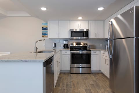 Cook with ease in a bright kitchen with stainless appliances.