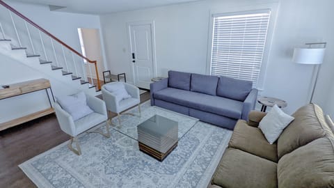 Seating for 8! Blue couch is a queen size fold out with sheets/pillows provided!