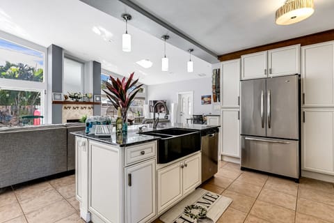 The kitchen overlooks the large oversize living room with a very high ceiling. 