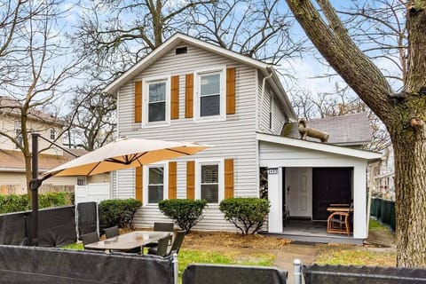 Fenced front with umbrellas, tables, chairs and a statue of my besties fray frays.