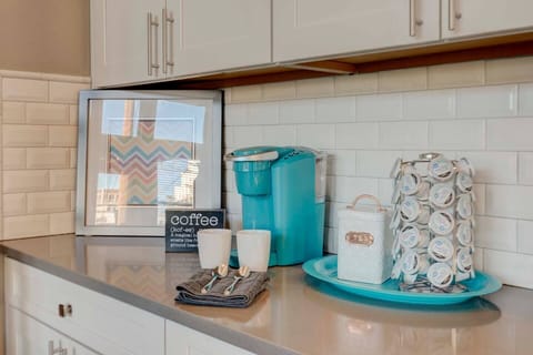 Kuerig coffee maker with coffee pods, creamer, sugar, honey, sweetener.