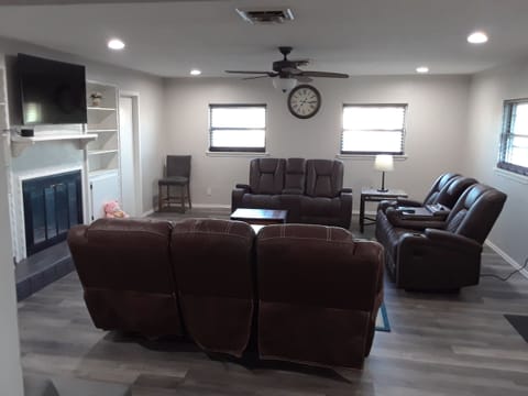 Large living room with 2 Sofas and a loveseat.
