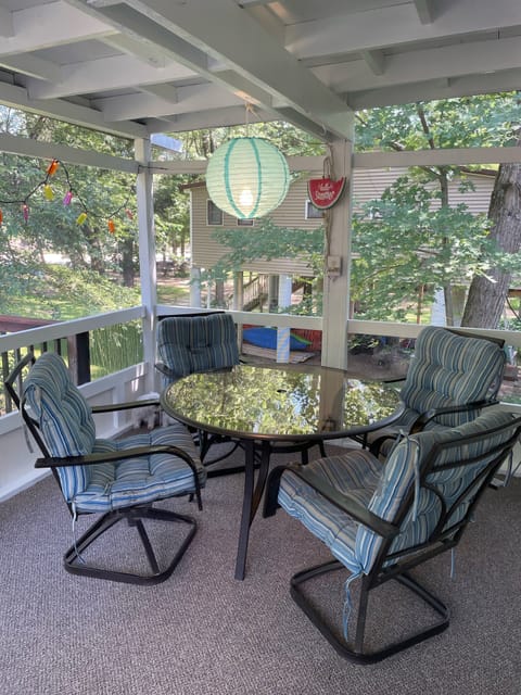 Two tables on the screen porch provide seating for 8.