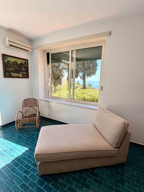 Casa Bougainville's bright double living room overlooks the garden and the sea.