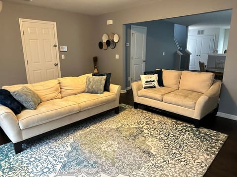 Spacious living room with plush seating for 6 guests in this Charlotte Airbnb near Uptown