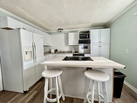 Modem kitchen with dishwasher, stove, kettle, coffee makers and cooking utensils