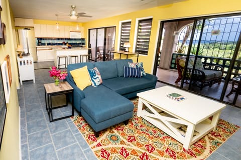 Main living area - with kitchen in background and patio doors to patio/gallery. 