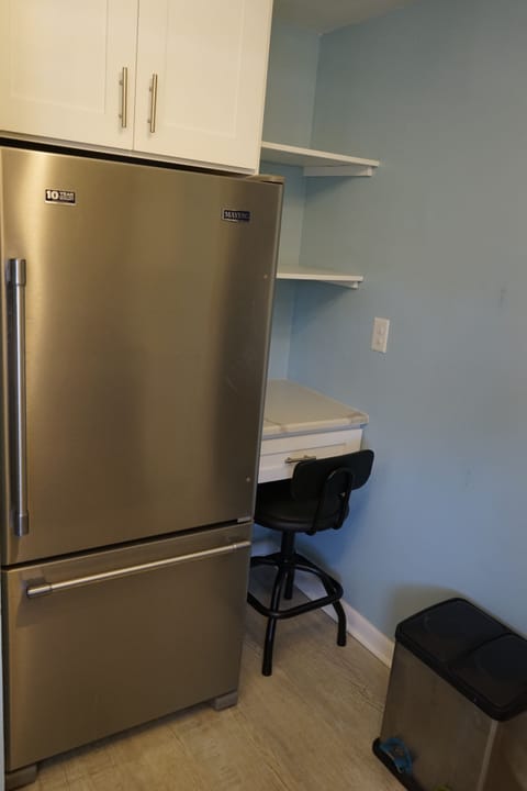 Kitchen refrigerator and desk, shelves and chair