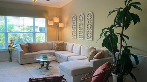 Spacious, cathedral ceiling living room with mounted TV
