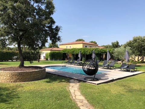 Pool area with deckchairs and parasols. Serenity Rentals Vacation Rentals