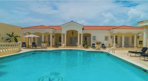 Large pool and home facade.