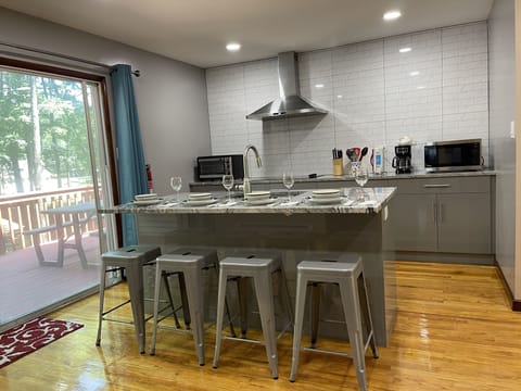 4 Bar stools on 6' center island with sliding patio door access to upper deck.