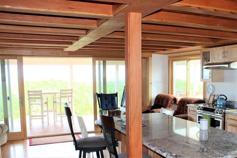 Open concept kitchen and living room with large windows to enjoy plenty of natural light.