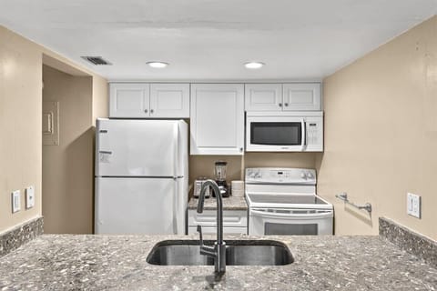 Fully equipped and appointed kitchen, featuring an assortment of utensils, silverware, dinnerware, small appliances and cookware to prepare meals of all sizes