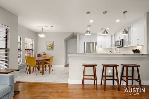 Large kitchen with bar seating and dining area