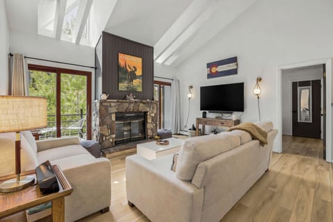 Living room with electric fireplace, 65" TV, private deck