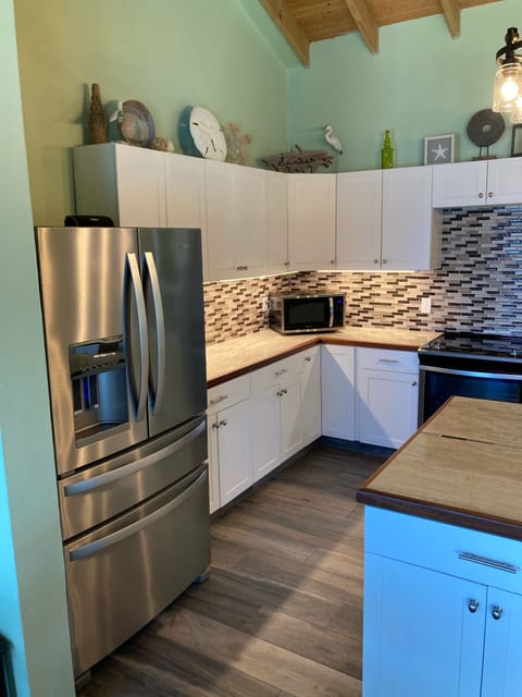 Large refrigerator with separate drink drawer and freezer on the bottom 