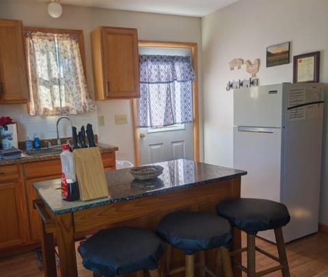 Kitchen has mobile island for extra cooking space or as dinette for meals.