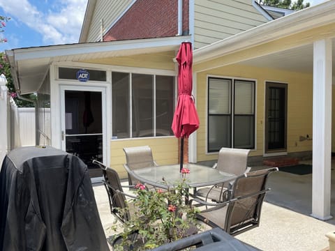 Patio Table, Chairs and charcoal Grill w/ privacy fence